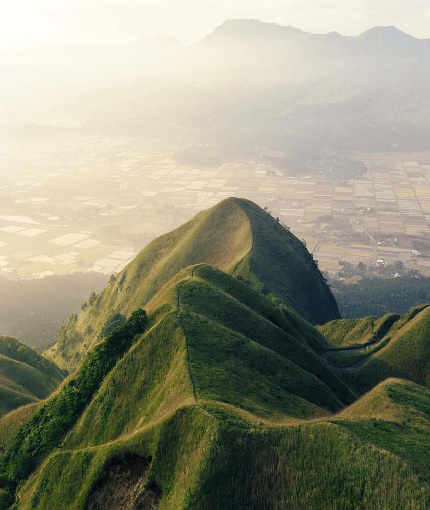 View from Kusasenri, a popular viewpoint from which to see the verdant outer rim of Mount Aso in Kumamoto Prefecture, Japan.